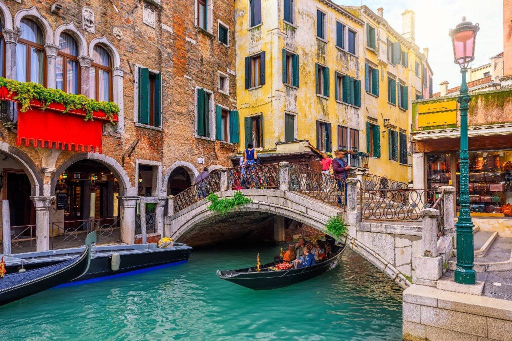 Narrow,Canal,With,Gondola,And,Bridge,In,Venice,,Italy.,Architecture