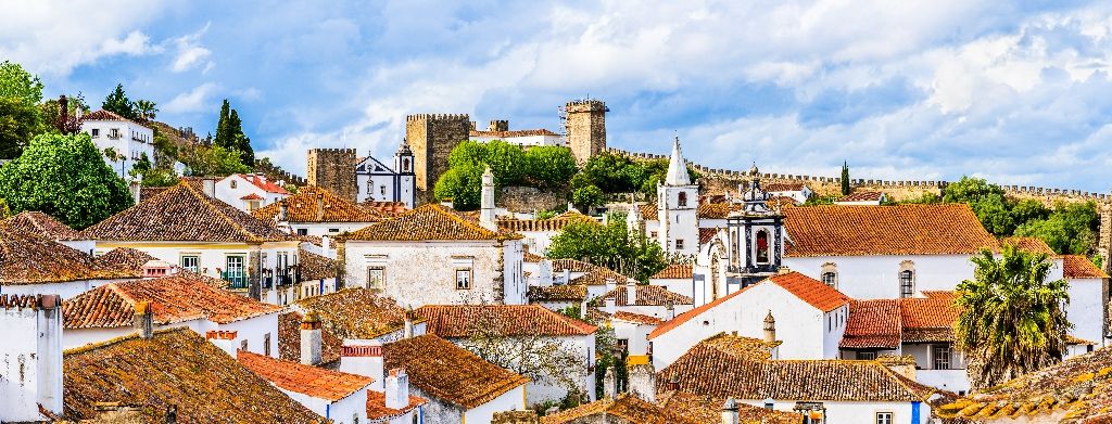 Obidos,,Portugal:,Old,Town,Skyline,With,House,Roof,Tops,,Church
