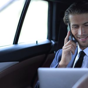 businessman in his car talking on the smartphone