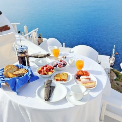 Breakfast,On,A,Terrace,Overlooking,The,Sea,In,Oia,,Santorini,