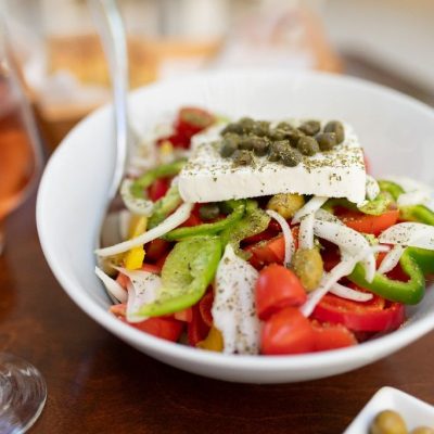 Traditional,Greek,Salad,And,Carafe,Of,Wine,In,A,Tavern