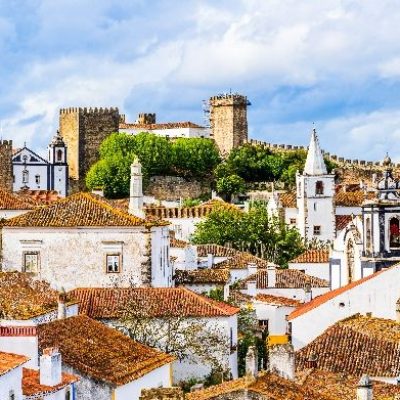 Obidos,,Portugal:,Old,Town,Skyline,With,House,Roof,Tops,,Church