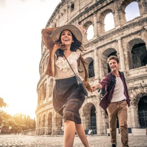 Young,Couple,At,The,Colosseum,,Rome,-,Happy,Tourists,Visiting